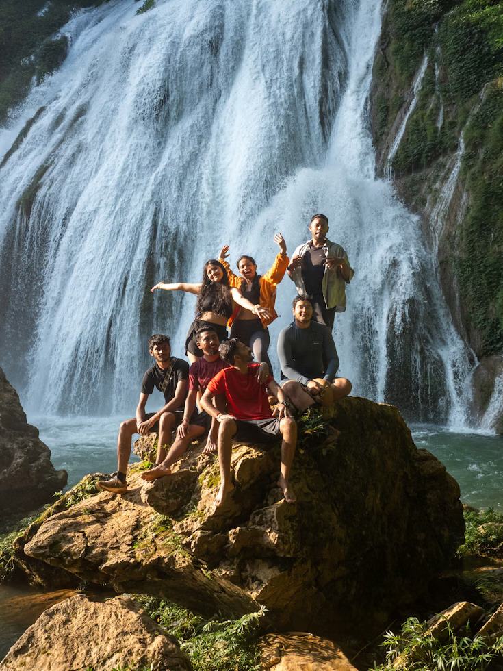 Group of travelers at a waterfall